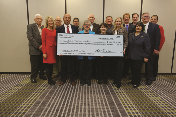 Picture of TLIE Board Members holding distribution check